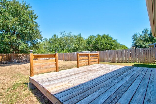 wooden terrace with a lawn