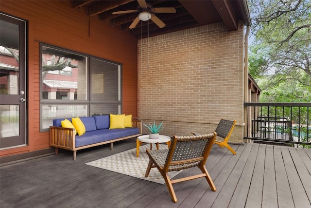 deck featuring outdoor lounge area and ceiling fan