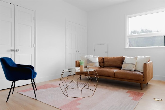 living room with baseboards and wood finished floors