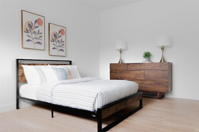 bedroom with wood finished floors and baseboards