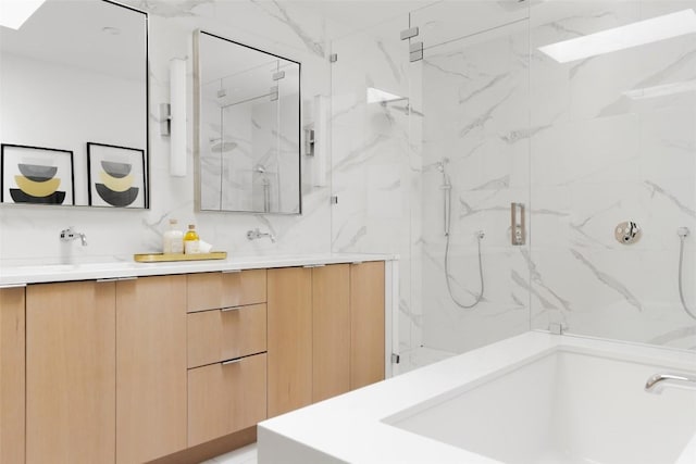 bathroom with a shower with door, vanity, and tasteful backsplash