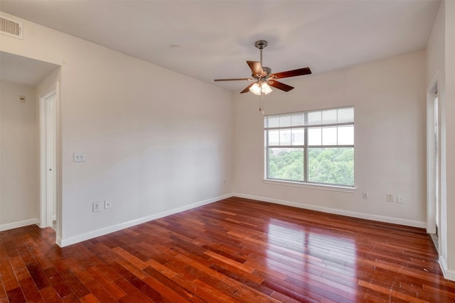 unfurnished room with dark hardwood / wood-style flooring and ceiling fan