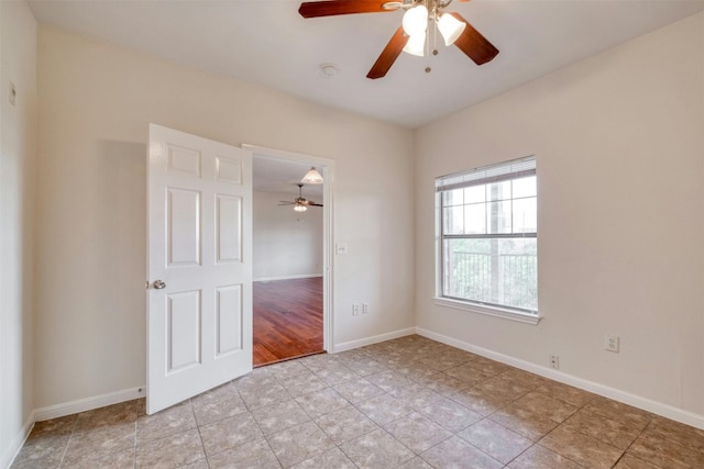 spare room featuring ceiling fan and light hardwood / wood-style floors