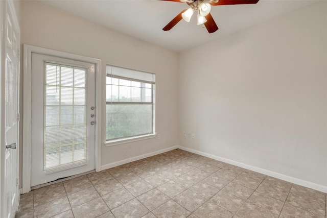 spare room with light tile patterned floors and ceiling fan