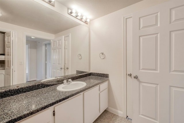 bathroom featuring vanity and a textured ceiling