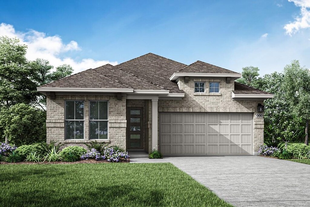 view of front of house featuring a garage and a front yard