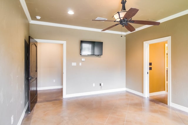 tiled spare room featuring ceiling fan and ornamental molding