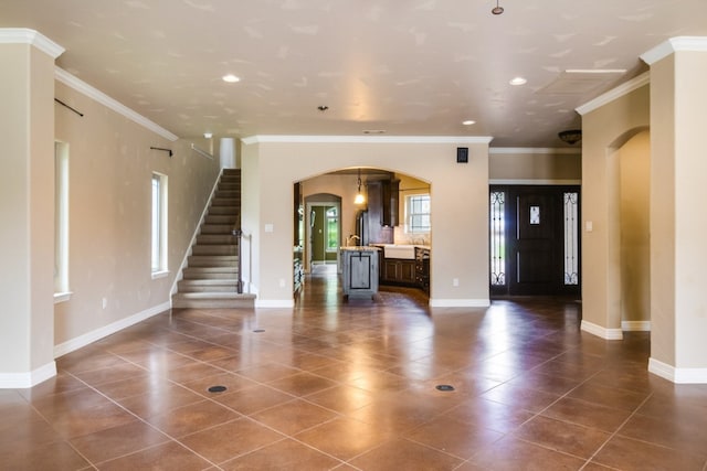 interior space featuring crown molding and dark tile patterned flooring