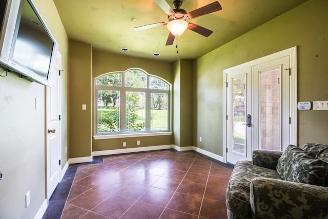 interior space with ceiling fan and french doors