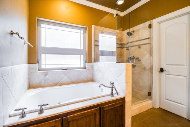 bathroom featuring tile patterned flooring, shower with separate bathtub, and crown molding