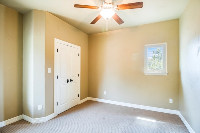 spare room featuring carpet flooring and ceiling fan