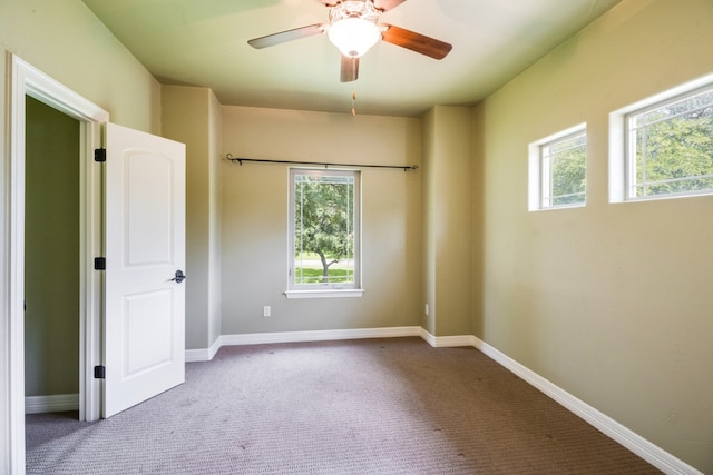 unfurnished bedroom with ceiling fan and carpet