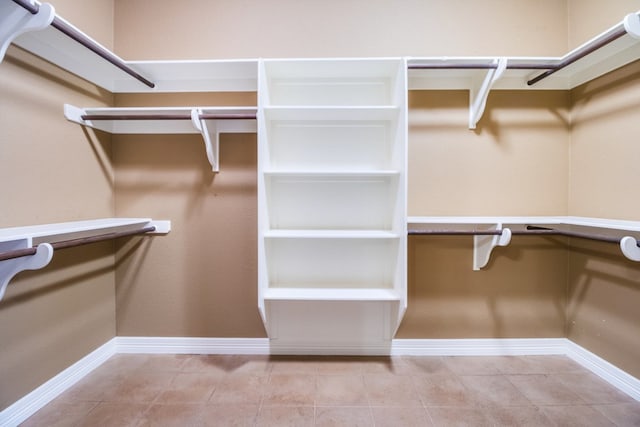 spacious closet featuring light tile patterned floors