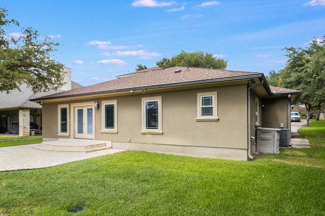 back of property featuring a lawn and a patio area