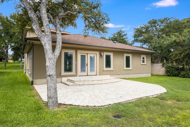 back of property with a yard and a patio area