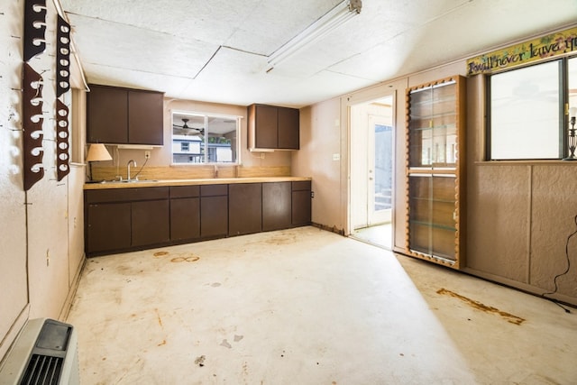 kitchen with sink and dark brown cabinetry