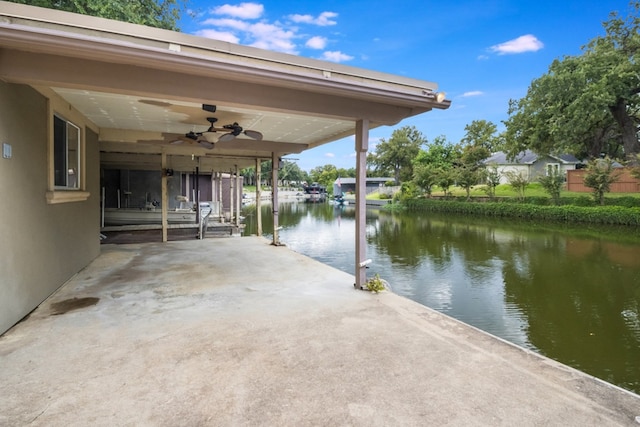 view of patio / terrace featuring a water view and ceiling fan