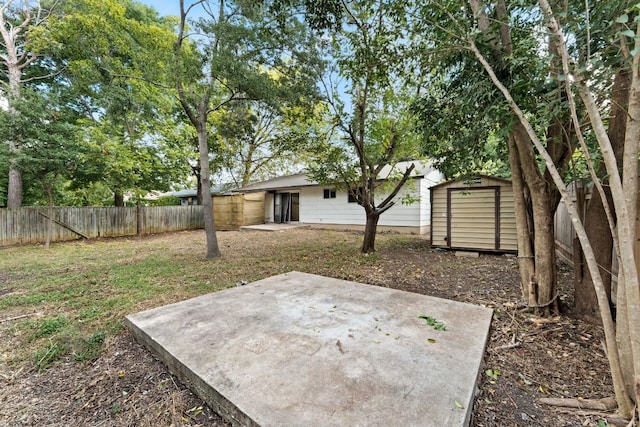 view of yard with a storage shed and a patio area