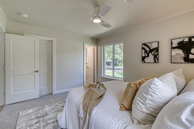 bedroom featuring ceiling fan, ornamental molding, and light carpet