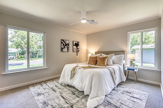 carpeted bedroom featuring ceiling fan and ornamental molding