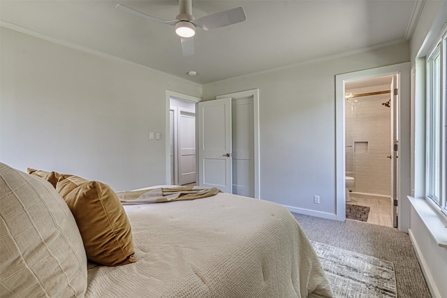 carpeted bedroom featuring ceiling fan, ornamental molding, ensuite bathroom, and multiple windows