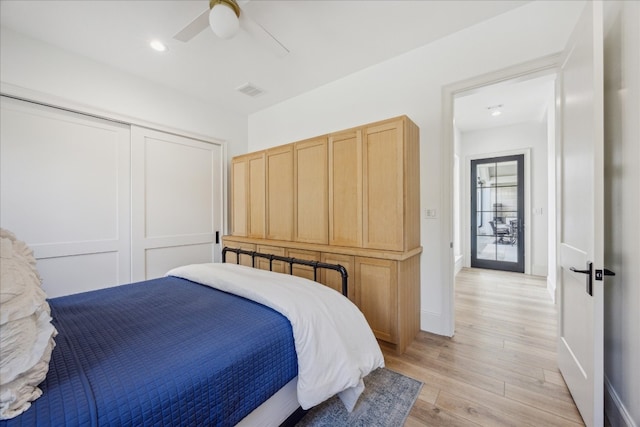 bedroom with a closet, ceiling fan, and light wood-type flooring