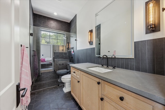 bathroom with a bidet, tile patterned flooring, tile walls, vanity, and toilet