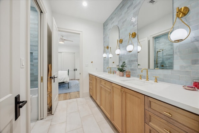 bathroom with vanity, tile patterned flooring, and decorative backsplash