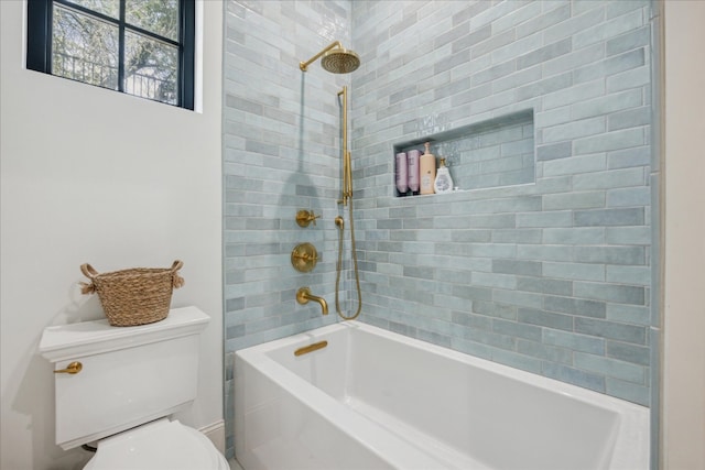 bathroom with tiled shower / bath and toilet