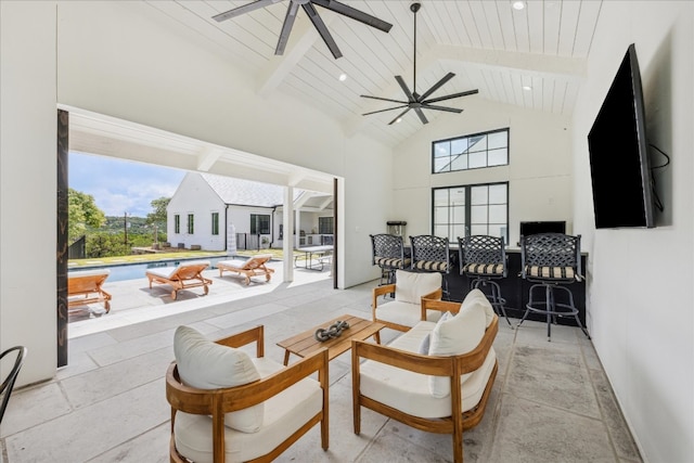 living room featuring wood ceiling, ceiling fan, beam ceiling, and high vaulted ceiling