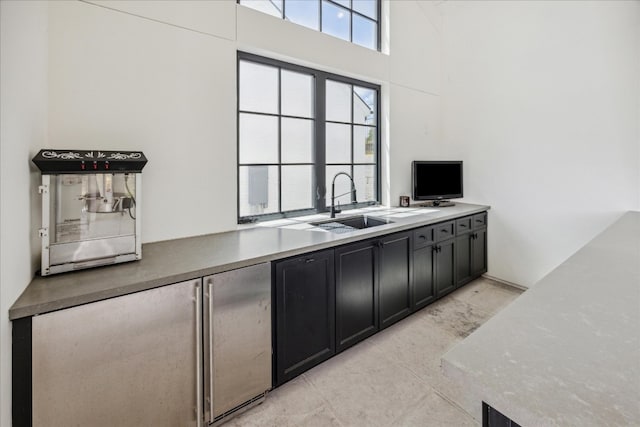 kitchen with sink and a towering ceiling