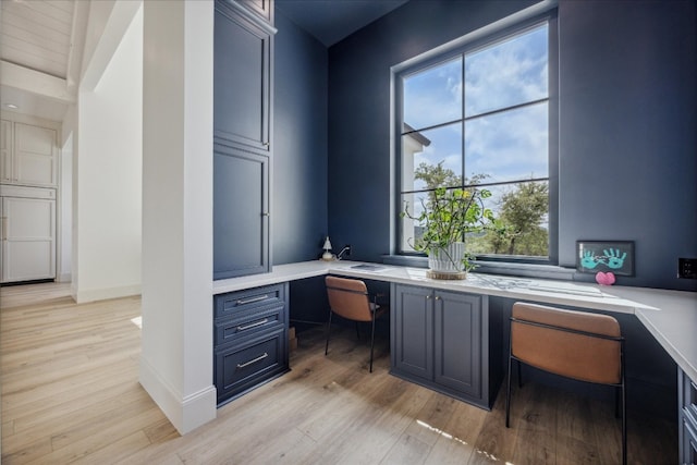 office area with built in desk and light wood-type flooring