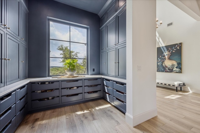 interior space featuring plenty of natural light, gray cabinets, and light wood-type flooring