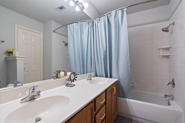 bathroom featuring shower / tub combo and vanity