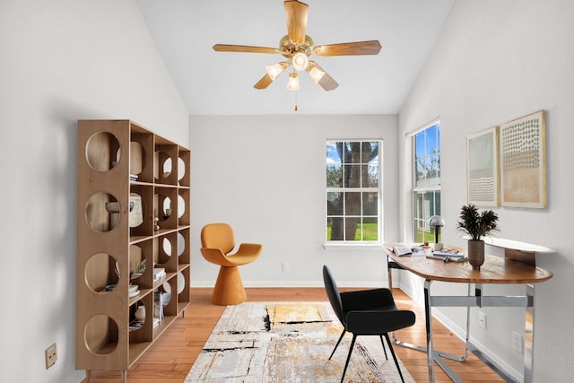 office space featuring ceiling fan, lofted ceiling, and light hardwood / wood-style floors