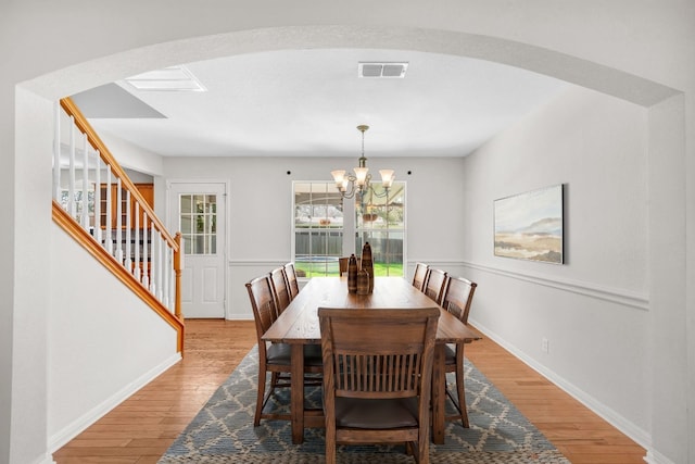 dining room featuring light hardwood / wood-style floors and a notable chandelier