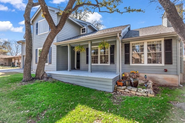 back of property with a porch and a lawn