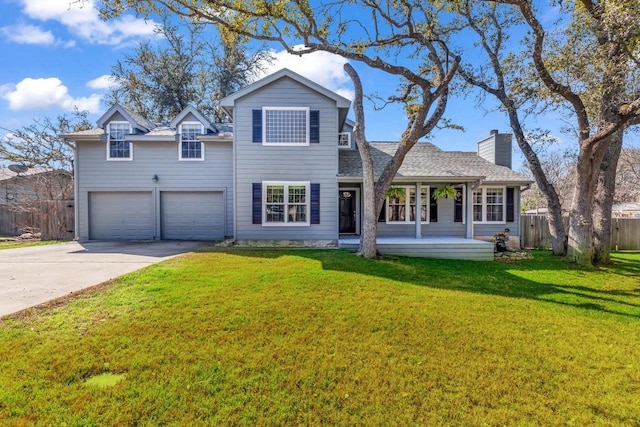 view of front of house featuring a garage, a porch, and a front yard