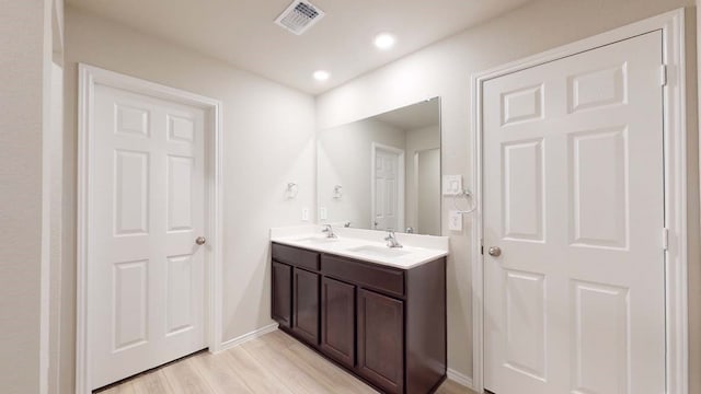 bathroom with vanity and hardwood / wood-style floors