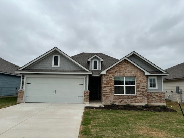 craftsman inspired home with a garage and a front lawn