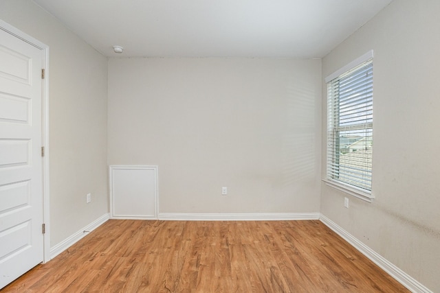 empty room with light wood-type flooring and plenty of natural light