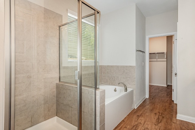 bathroom featuring hardwood / wood-style floors and independent shower and bath