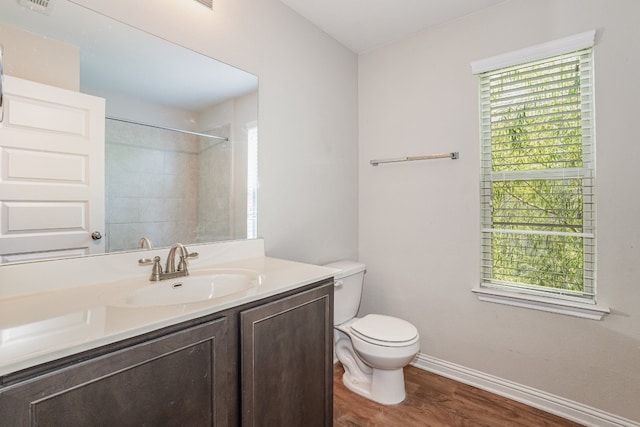 bathroom featuring hardwood / wood-style floors, toilet, plenty of natural light, and vanity