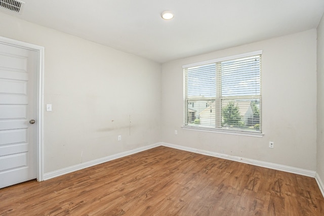 spare room with hardwood / wood-style flooring