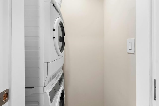 laundry area with stacked washer and dryer