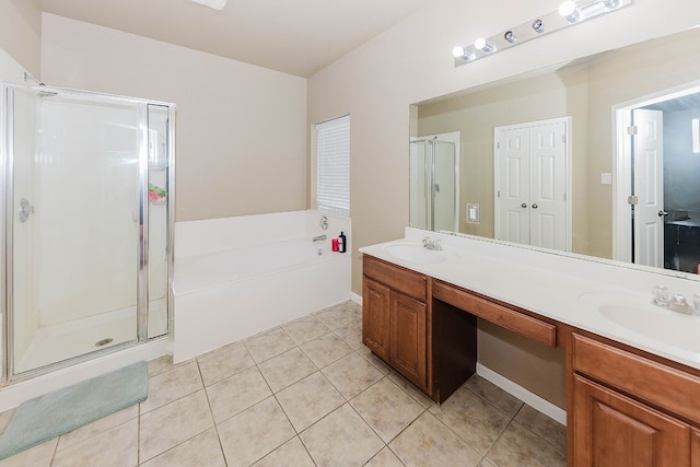 bathroom featuring tile patterned flooring, vanity, and shower with separate bathtub