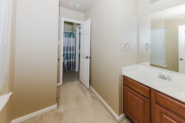 bathroom featuring vanity and a shower with shower curtain