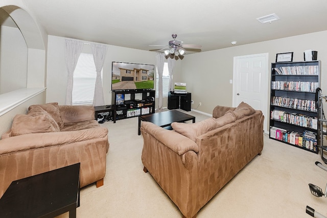 living room with ceiling fan and light colored carpet