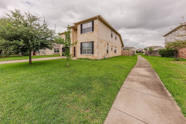 view of side of property with a yard