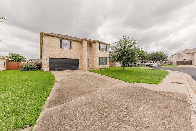 view of front of home featuring a front yard and a garage